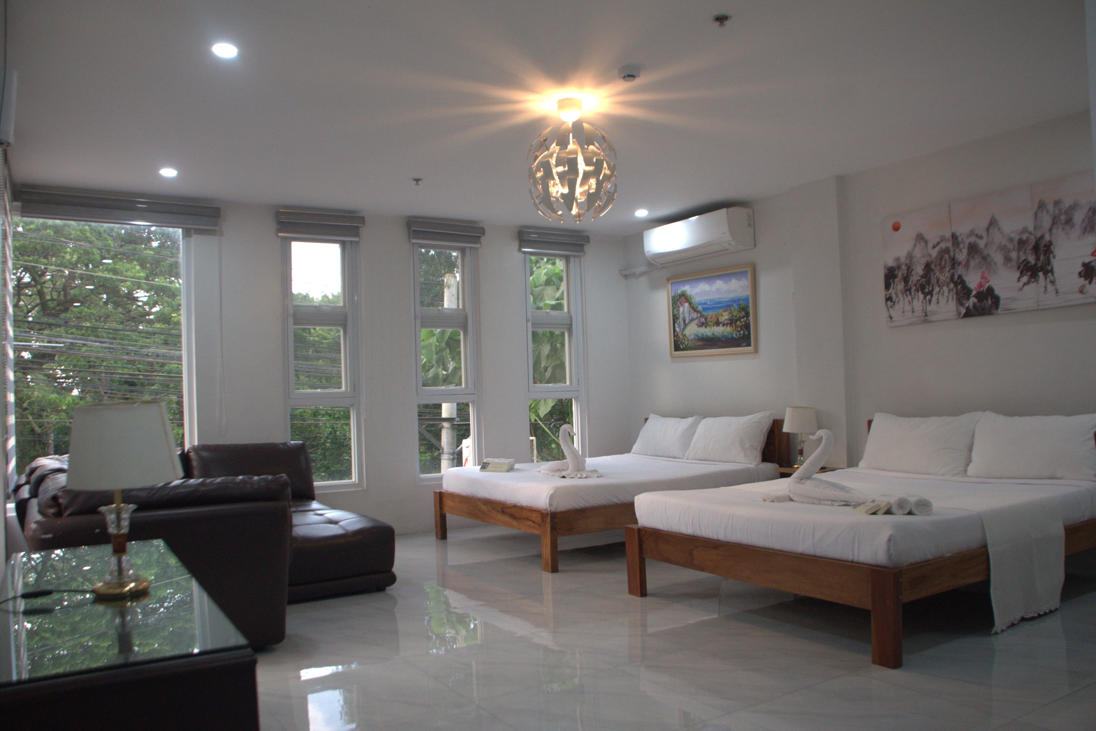 Elegant Leribi Suites guest room with warm lighting and premium bedding